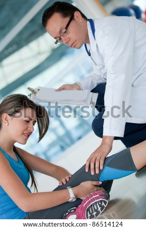 Athletic injured woman in physiotherapy at the gym