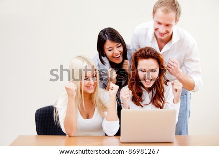 Successful business group going online on a laptop at the office