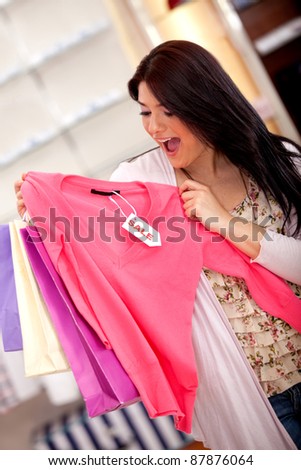 Excited woman shopping for clothes on sale