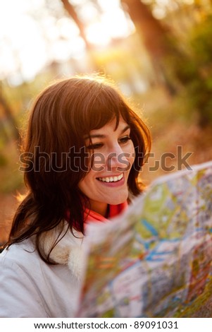Female explorer holding a map at the countryside