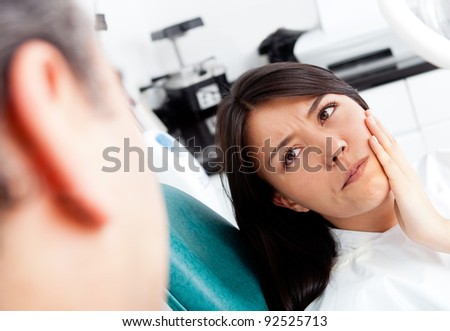 Woman at the dentist complaining about a tooth pain
