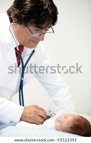 Doctor listening to the heart of a baby with a stethoscope