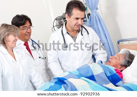Doctors checking on an old patient at the hospital