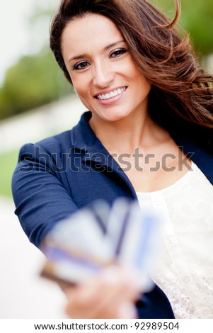 Latin woman holding credit cards - financial solutions