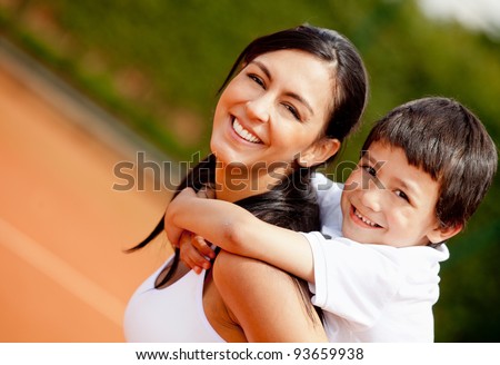 Lovely portrait of a mother and son at the tennis court