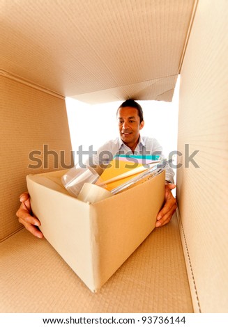 Man packing in cardboard boxes to move house