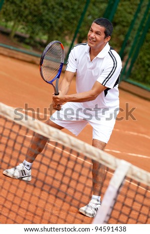Male tennis player waiting for a service