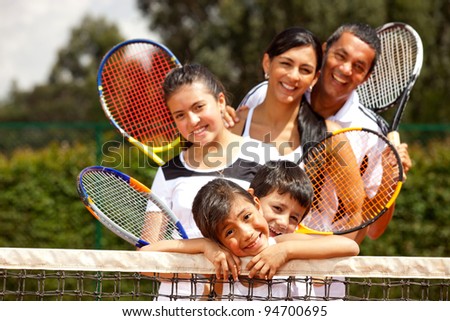 Portrait of a group of tennis players smiling outdoors