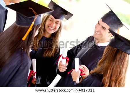 Group of happy graduation students talking outdoors