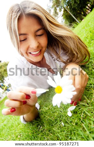 Woman in love holding a daisy and playing loves me or not