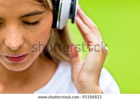 Woman portrait listening to music with headphones