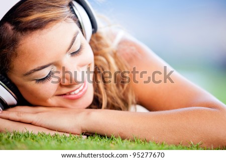 Relaxed woman lying on the floor and listening to music
