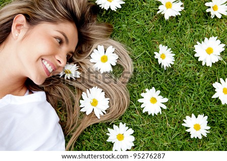 Beautiful woman lying in a garden of flowers