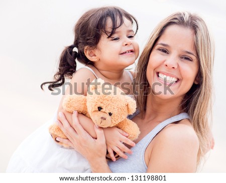 Mother and daughter portrait with a teddy bear