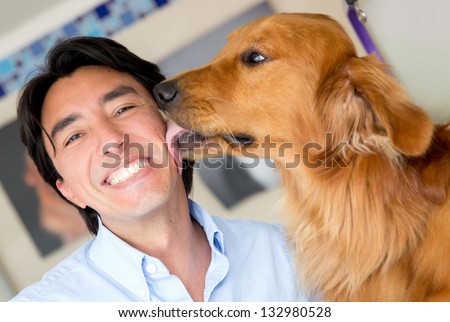 Golden Retriever Licking His Owner In The Face As A Sign Of Affection