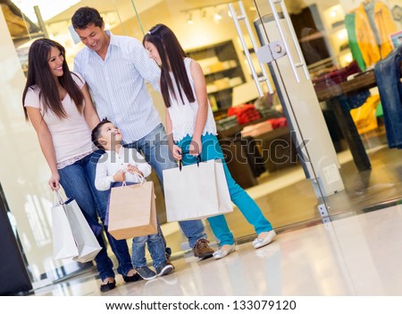 Happy Family With Shopping Bags At The Mall