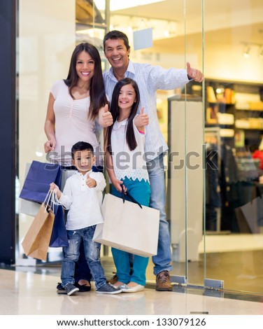 Happy family shopping with thumbs up and smiling