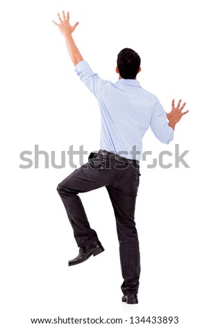 Business man climbing a wall - isolated over a white background