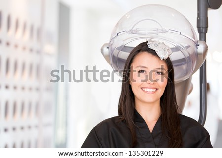 Woman at the hair salon changing her color