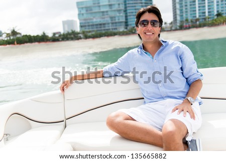 Handsome man relaxing on a yacht enjoying the summer