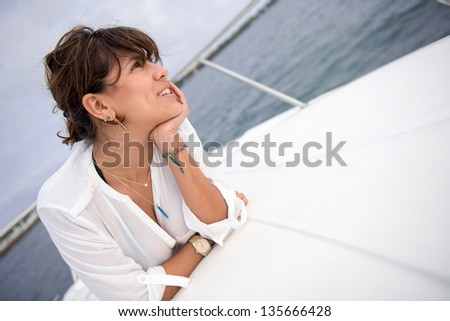 Beautiful thoughtful woman relaxing in a boat