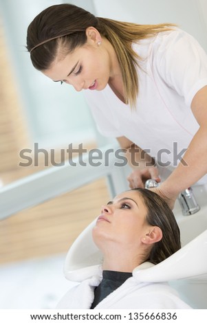 Woman washing hair at the beauty salon