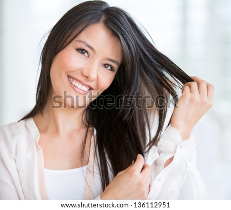 Happy woman at the beauty salon in need of a haircut