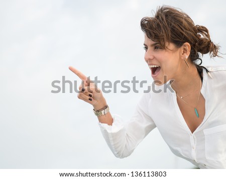 Portrait of a surprised woman pointing away
