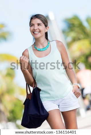 Happy casual woman walking in the streets of Miami