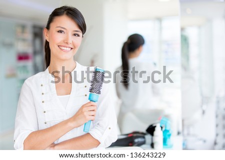 Beautiful woman at the beauty salon holding a hair brush Beautiful woman at the beauty salon holding a hair brush