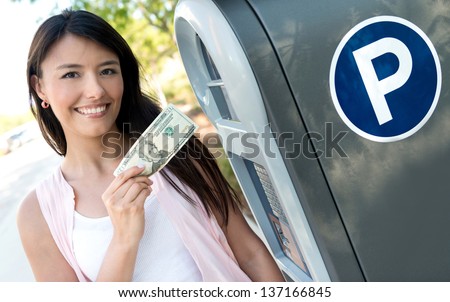 Portrait of a woman paying for parking in cash