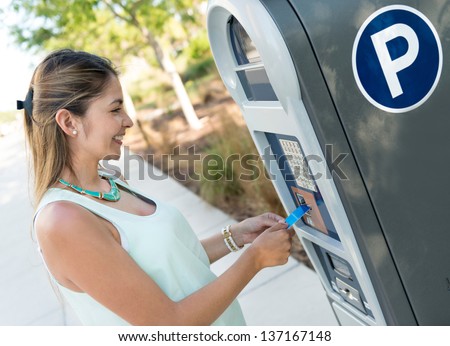 Woman paying for parking with a debit card