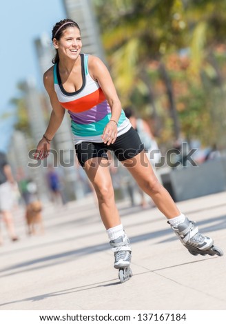 Woman skating outdoors by the beach in Miami