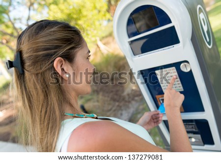 Woman paying for parking with a credit card