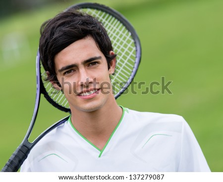 Male tennis player holding racket at the court