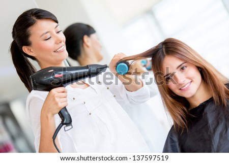 Woman with long hair at the beauty salon getting a blower Woman with long hair at the beauty salon getting a blower