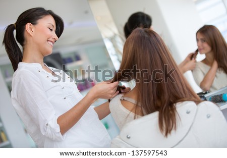 Woman at the hair salon getting a haircut beauty concepts Woman at the hair salon getting a haircut beauty concepts