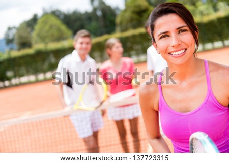 Female tennis player with a group of friends at the court