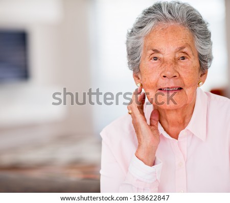 Portrait of a beautiful elder woman smiling at home