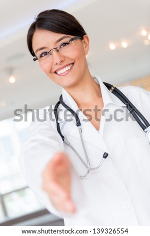 Welcoming doctor with hand extended to handshake