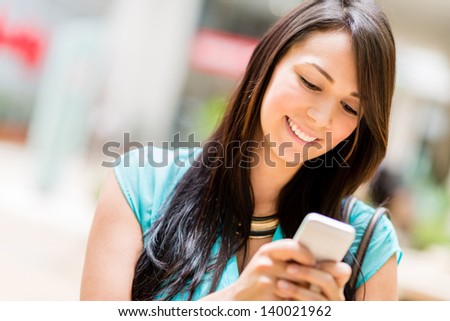 Portrait Of A Woman Sending Text Message From Her Phone