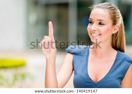 Business woman pointing with her finger touching an imaginary screen