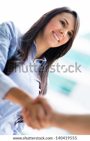 Business Woman Giving A Handshake And Smiling