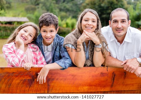Portrait of a sweet family enjoying outdoors in the countryside