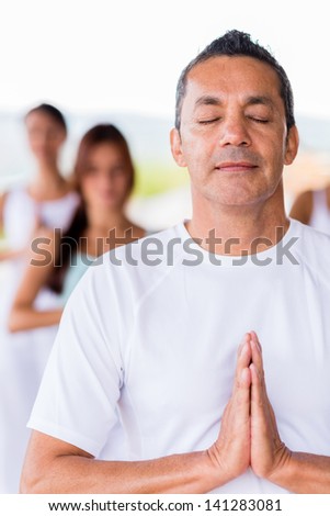 Man doing yoga with eyes closed looking very relaxed