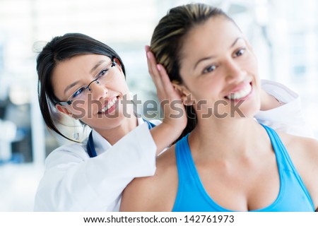 Gym Doctor Checking On A Female Patient For Neck Injury