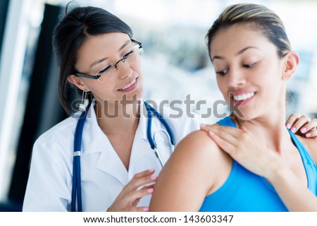Gym doctor with a patient checking a back injury