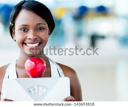 Healthy eating woman holding scale and an apple