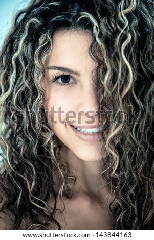 Beauty portrait of a woman with beautiful curls in her hair