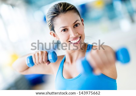 Strong Woman Weightlifting At The Gym Looking Happy